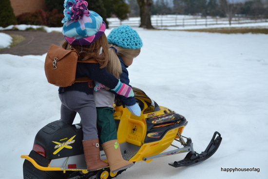 American Girl dolls Emily and Isabelle on snowmobile